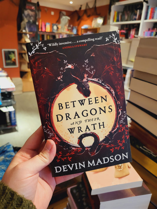 Between Dragons and their Wrath - Devin Madson